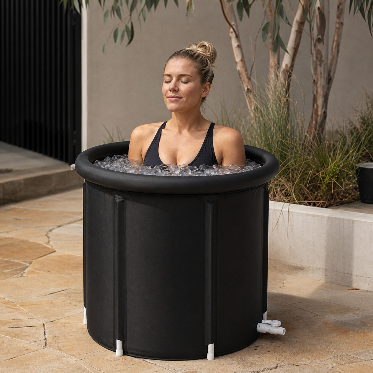 Person stepping into a portable ice bath outdoors